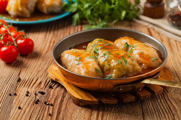 Traditional stuffed cabbage with minced meat and rice, served in a tomato sauce.