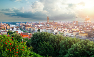 Fototapeta na wymiar Firenze. Florence landmarks. Cityscape skyline of Florence Italy with Duomo, Basilica di Santa Maria del Fiore and the bridges over the river Arno against cloudy sky.