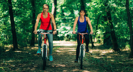 Naklejka premium Two Women Cycling Together