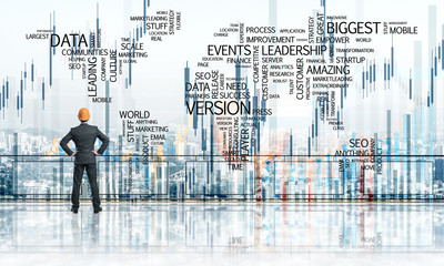 Sunrise above skyscrapers and engineer in helmet facing new day