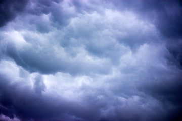 Waiting the storm to come. Heavy dark blue storm clouds in the sky and lightning strikes all...