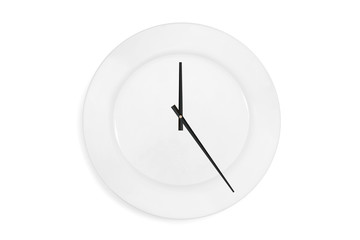 Top view of a empty serving plate as a clock with arrows on the white background. Concept. Isolated