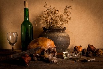 Human skull and flower vase old treasure on wooden table background, Still life concept