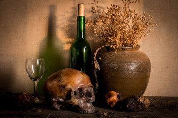 Human skull and flower vase old treasure on wooden table background, Still life concept