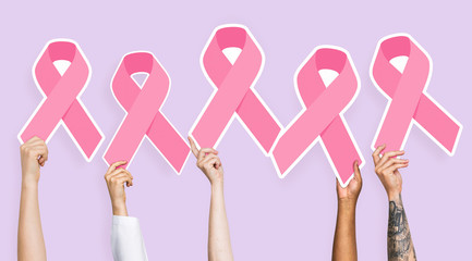 People holding breast cancer awareness ribbons