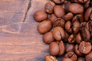 coffee beans on a wooden background scattered