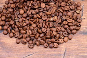 coffee beans on a wooden background scattered