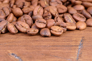 coffee beans on a wooden background scattered