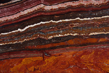 Red background with stone structure with stripes Onice Fantastico