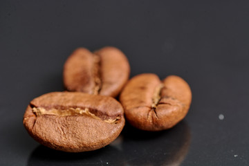 coffee beans on black background consistent with