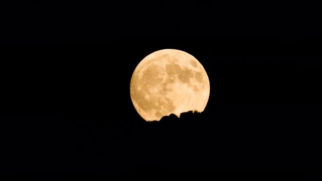 Super moon rising over mountains