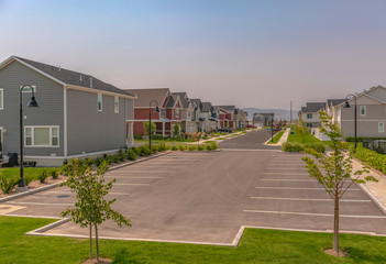 HOmes and parking lot against mountain and sky