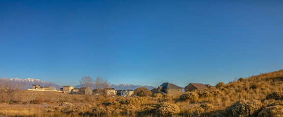 Homes on a hill against moountain and sky in Utah