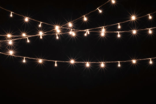 Christmas Lights, Garland with Small  Led Lamps Shining on Black Background.