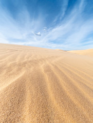 Fototapeta premium White sand dunes and blue sky background in Mui Ne , South of Vietnam