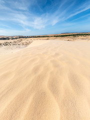 White sand dunes and blue sky background in Mui Ne , South of Vietnam