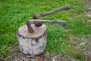 rusty ax in a log