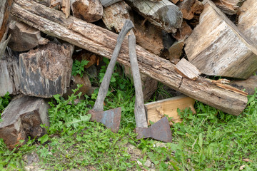 ax on the background of chopped firewood. old rotten firewood