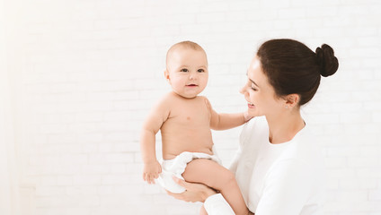 Mother with baby on bed having good time