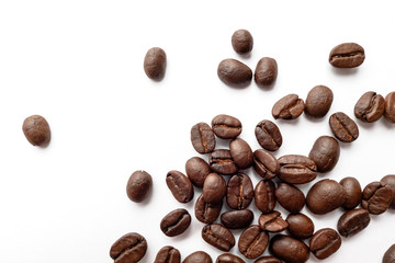 Roasted coffee beans isolated on white background. Close-up.