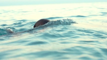 Girl in diving mask swimming underwater in sea. Swimming lessons