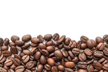 Roasted coffee beans on white background. Close-up.