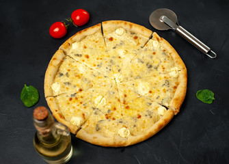 Delicious four cheese pizza on a concrete background. Top view of hot pizza. 