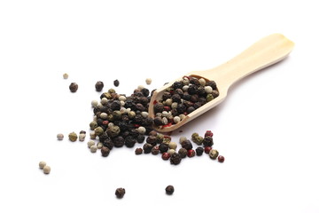 Colorful mixed pepper in wooden spoon isolated on white background