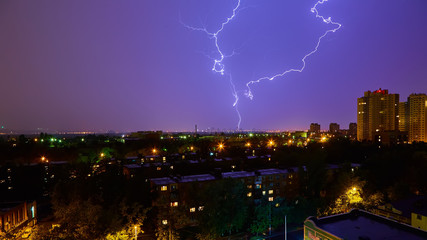 Lightning strike in the city Kyiv. Storm outside. Thunderstorm with lightning in the city. Moment...