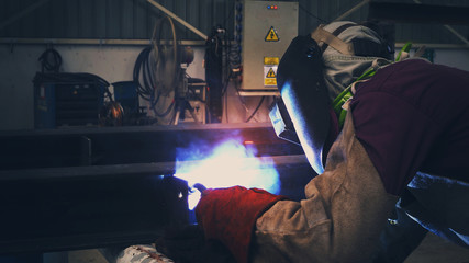 Obraz na płótnie Canvas Welder is welding flux cored arc welding Industrial welding part in Oil and Gas or Petrochemical ,Copy space for you text.