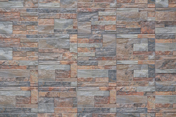 Modern tiled wall texture background in various brown and gray colors