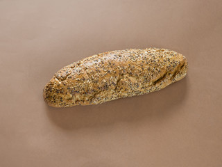 Bread with seeds on brown background