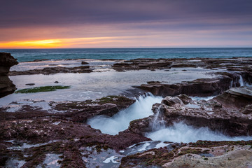Ocean eroding out channels in the rocks
