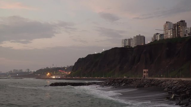 Sunset over sea, highway and buildings at Malec&radic;&ge;n de Miraflores, Lima, Per&radic;&int;. View from sea.