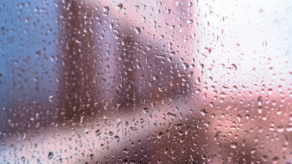 Obraz premium view of the city through wet glass as a background for artists