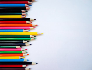 Color pencils on white background. Flat lay, top view, copy space