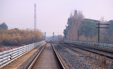 Fototapeta na wymiar View of two parallel tracks on the railway near a station