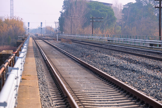 View of two parallel tracks on the railway near a station