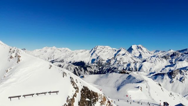 Skiers on beautiful ski slope in Alps, people on winter holidays. Winter mountain landscape
