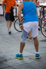 Man who Wears an Elastic Knee Support before a Marathon in Town