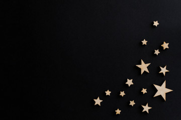 Wooden stars on a black background. Chalk board. Postcard. Men's Day. Night. Astronomy.