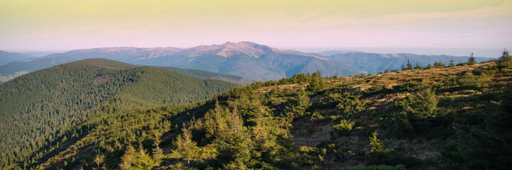 Fototapeta premium Panoramic view of idyllic mountain scenery in sunny day