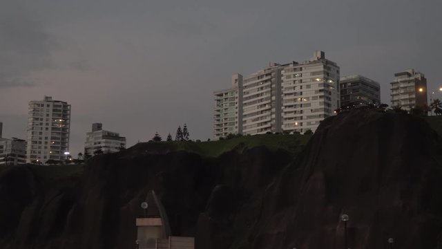 Sunset over buildings at Malec&radic;&ge;n de Miraflores, Lima, Per&radic;&int;. View from the sea.