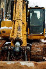 Fototapeta na wymiar bucket cylinder of old excavator in winter outdoor, close-up
