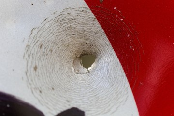 Bullet hole on a street sign.