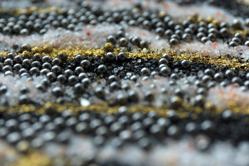 Layered blur sand pattern. Marble style background. Black and gold powder defocused texture.
