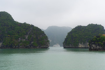 Halong Bay in mystical clouds. Mystical atmoshpere in the world famous halong bay.