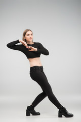Obraz premium Full length photo of beautiful sexy woman posing in the studio in the black casual clothes