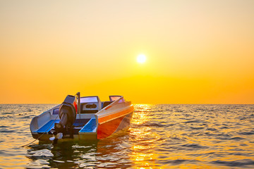 Sunset seascape with a motorboat