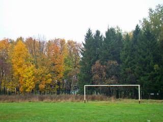 Old football goal on the country field in autumn